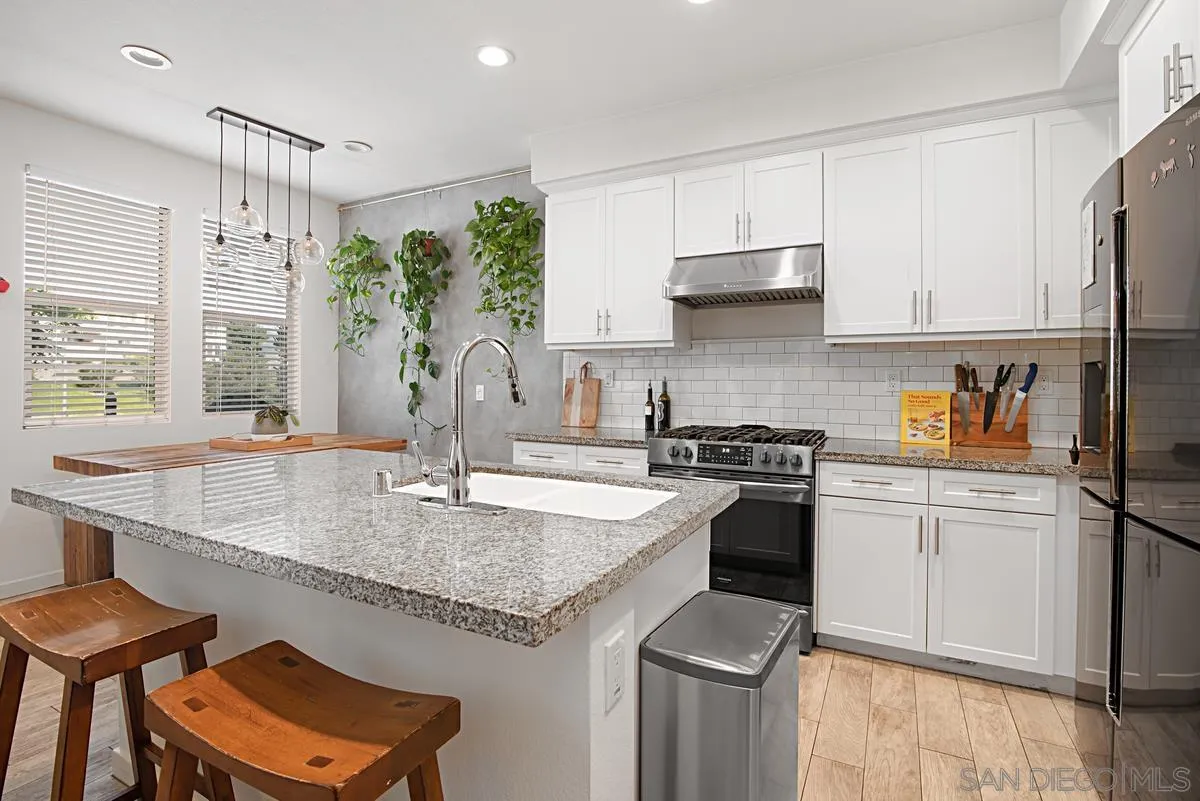 2036 Foxtrot Loop, Unit 4 Chula Vista, CA 91915 - Photo 12 of 33 a kitchen with stainless steel appliances granite countertop a sink stove and refrigerator