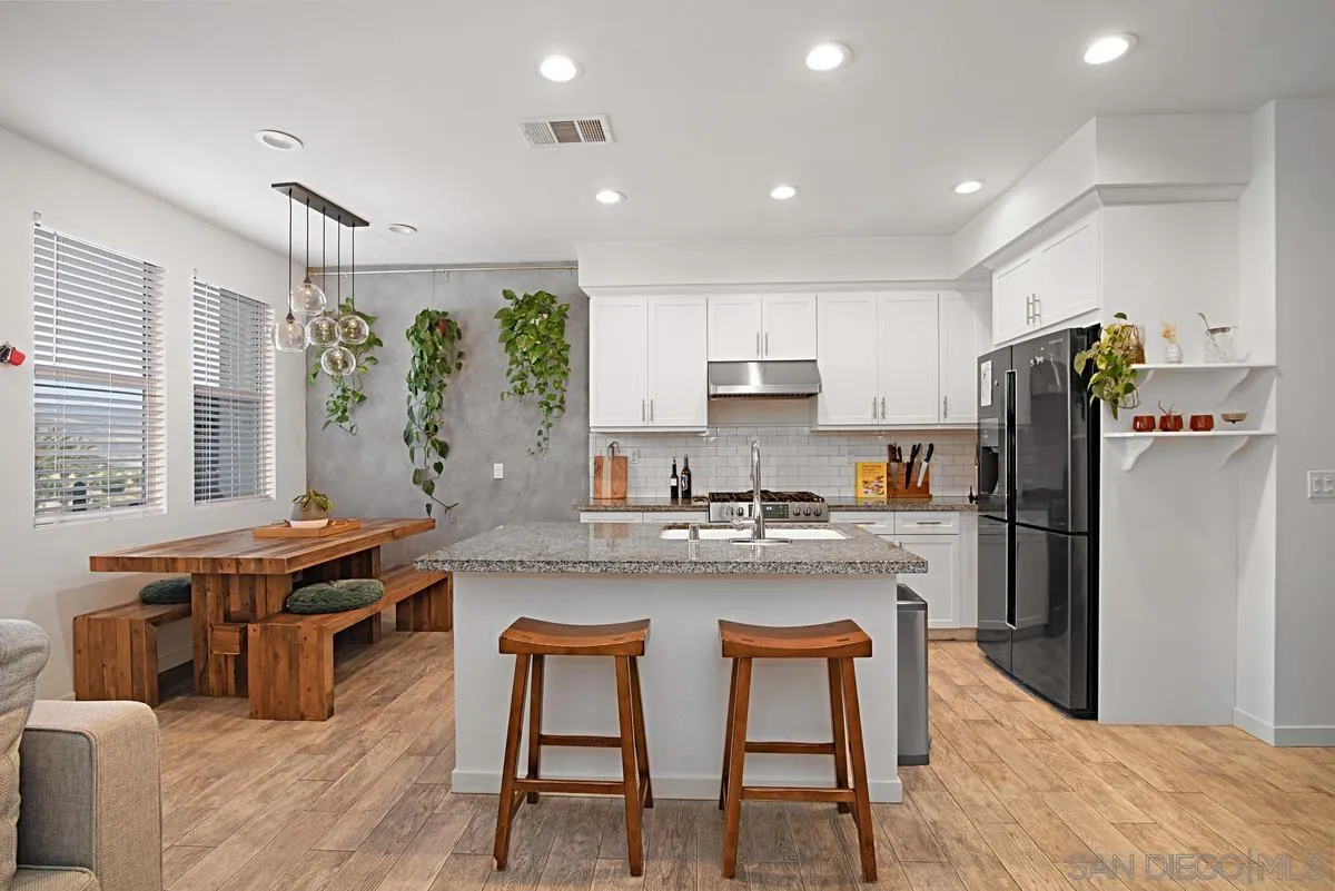 2036 Foxtrot Loop, Unit 4 Chula Vista, CA 91915 - Photo 13 of 33 a kitchen with stainless steel appliances granite countertop a stove a sink a refrigerator and a refrigerator
