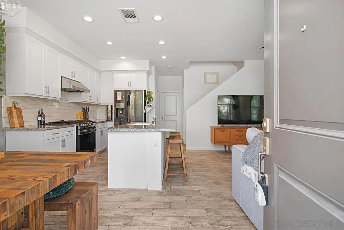 2036 Foxtrot Loop, Unit 4 Chula Vista, CA 91915 - Photo 14 of 33 a kitchen with stainless steel appliances granite countertop a stove top oven a sink a counter top space and cabinets