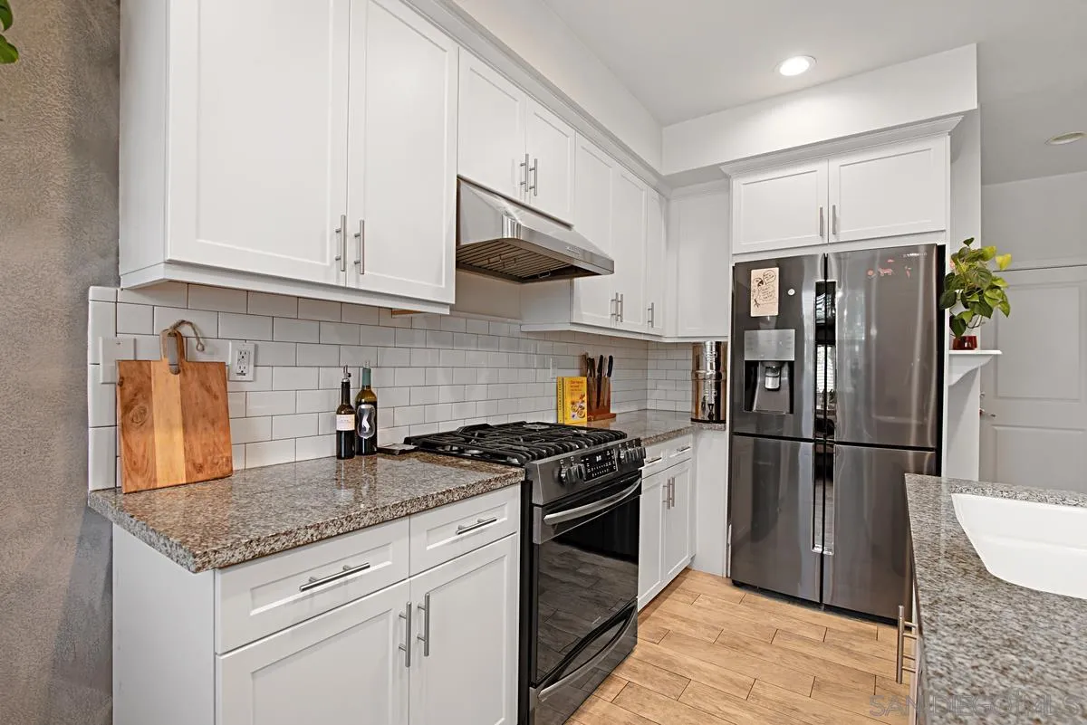 2036 Foxtrot Loop, Unit 4 Chula Vista, CA 91915 - Photo 18 of 33 a kitchen with stainless steel appliances granite countertop a sink stove and refrigerator
