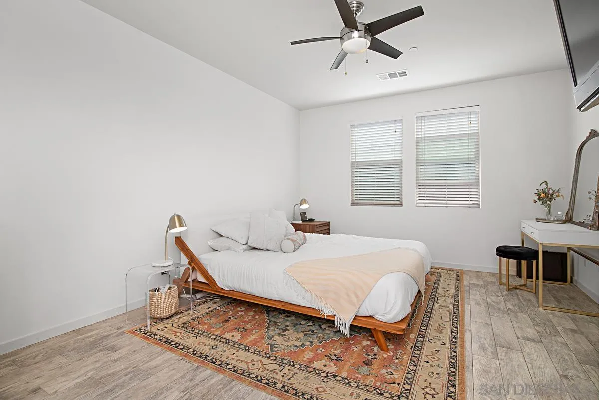 2036 Foxtrot Loop, Unit 4 Chula Vista, CA 91915 - Photo 22 of 33 a bedroom with a bed and wooden floor