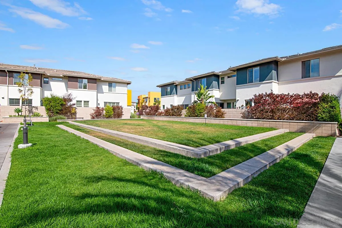 2036 Foxtrot Loop, Unit 4 Chula Vista, CA 91915 - Photo 30 of 33 a view of a house with a big yard with plants and large tree