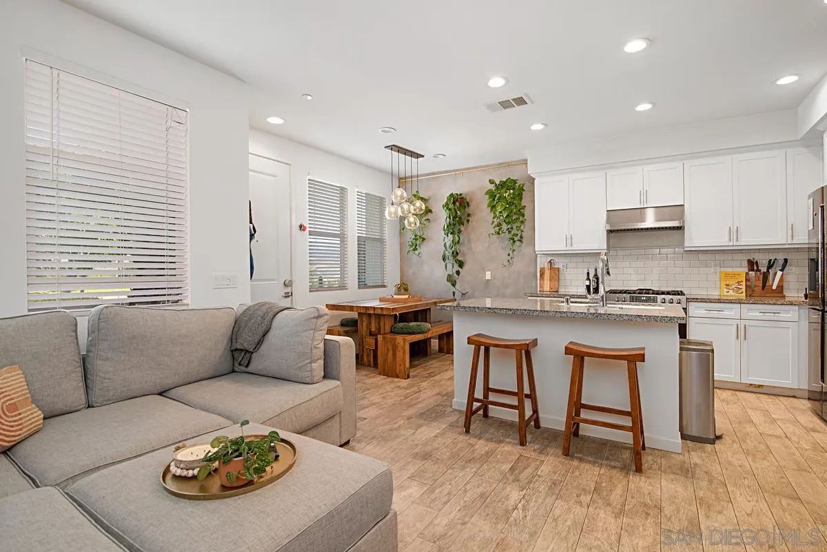 2036 Foxtrot Loop, Unit 4 Chula Vista, CA 91915 - Photo 3 of 33 a living room with furniture and a dining table with kitchen view