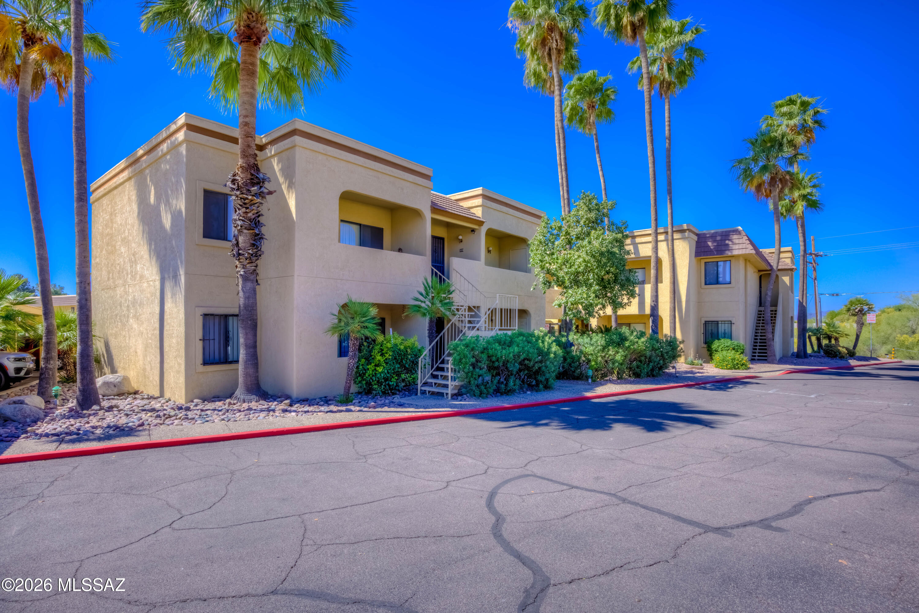 5500 North Valley View Road, Unit 123 Tucson, AZ 85718 - Photo 2 of 36 a front view of a house with a yard and a garage