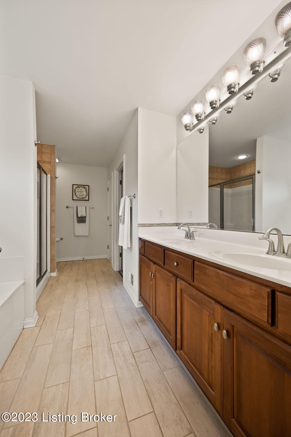 4610 Stone Ridge Road Crestwood, KY 40014 - Photo 24 of 52 The breathtaking ensuite full bath offers subway tile flooring (2020), a double vanity, a wall-to-wall mirror, sconce & recessed lighting, a linen closet, and fresh paint