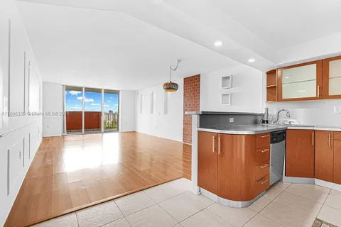 a large kitchen with stainless steel appliances granite countertop a large counter top and a stove