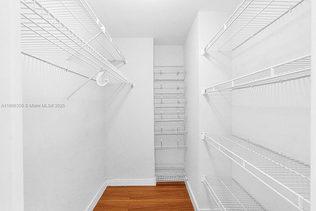 2780 Northeast 183rd Street, Unit 1511 Aventura, FL 33160 - Photo 9 of 29 a view of walk in closet with empty racks
