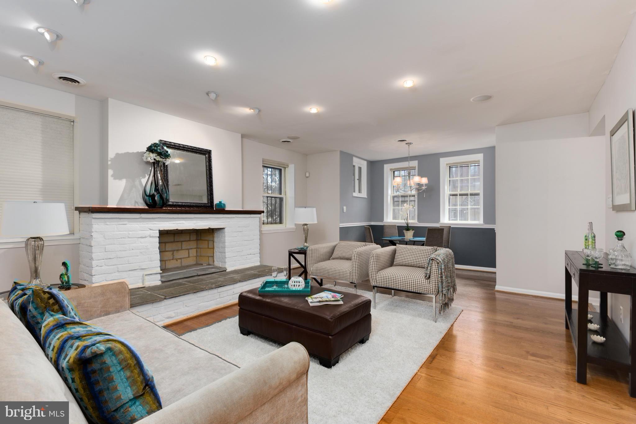 3035 Q Street Northwest, Unit 1 Washington, DC 20007 - Photo 2 of 19 a living room with furniture and a fireplace
