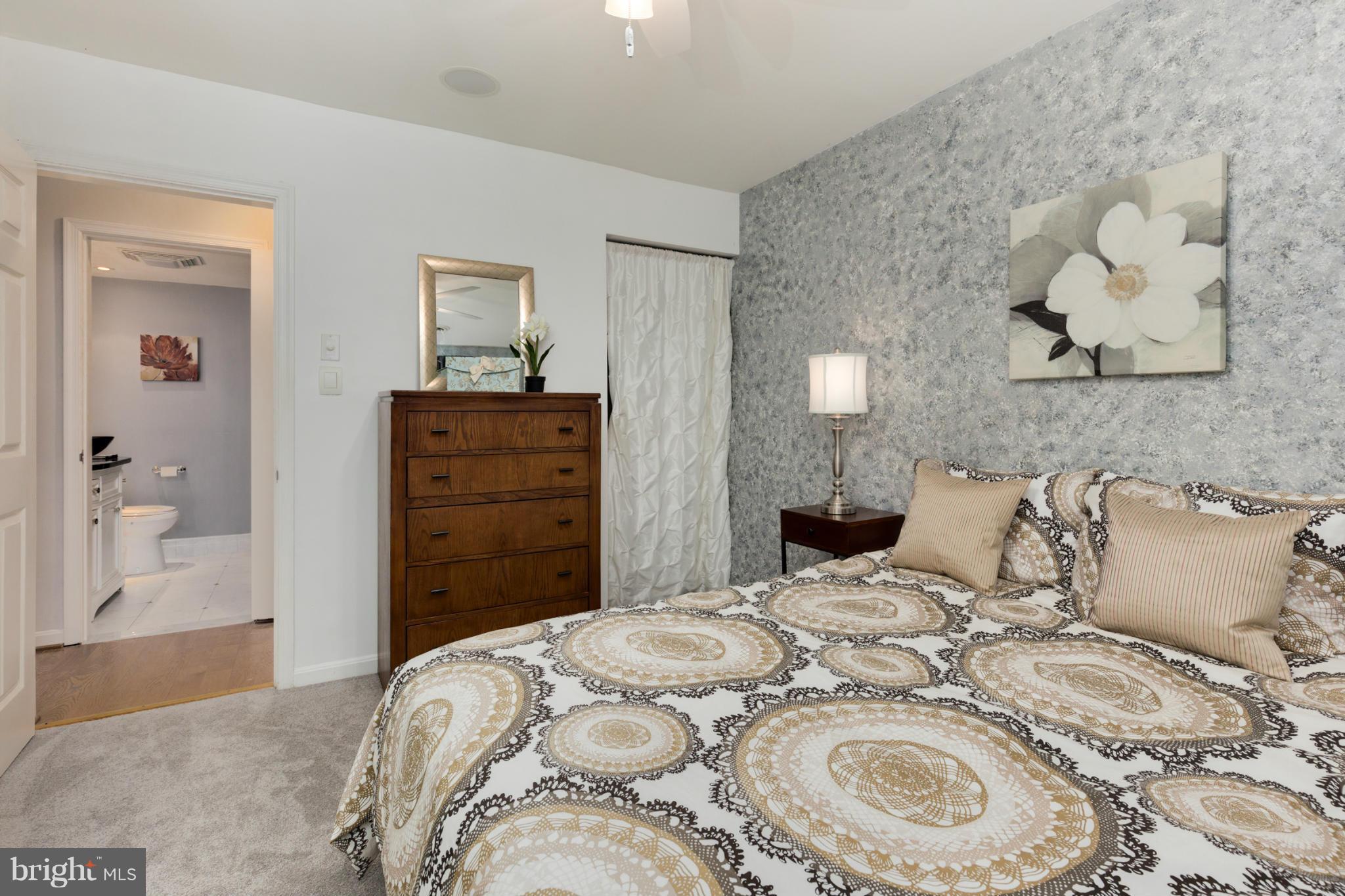 3035 Q Street Northwest, Unit 1 Washington, DC 20007 - Photo 11 of 19 a bedroom with a bed and a view of bathroom