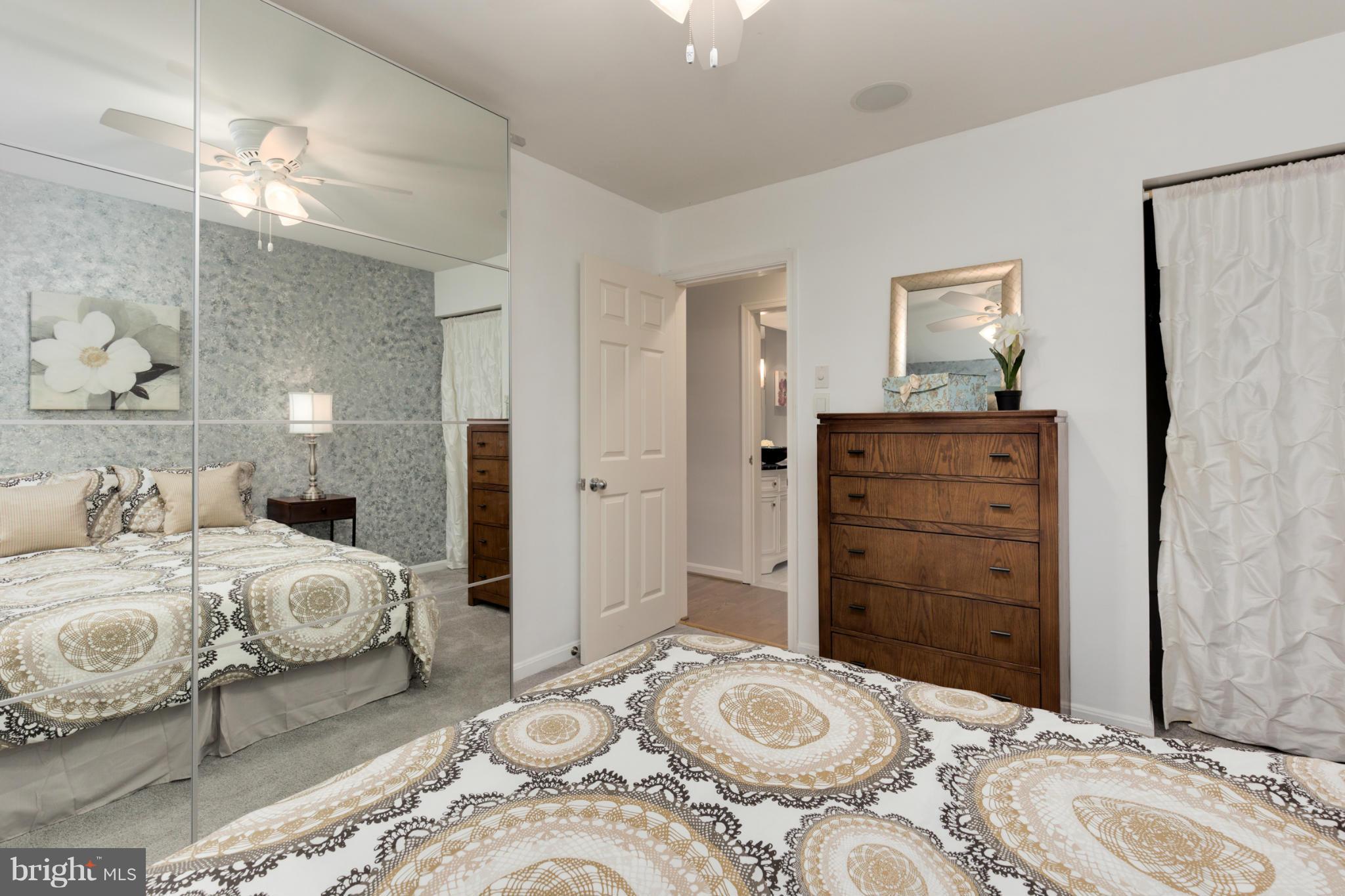 3035 Q Street Northwest, Unit 1 Washington, DC 20007 - Photo 12 of 19 a bedroom with a bed and wooden floor