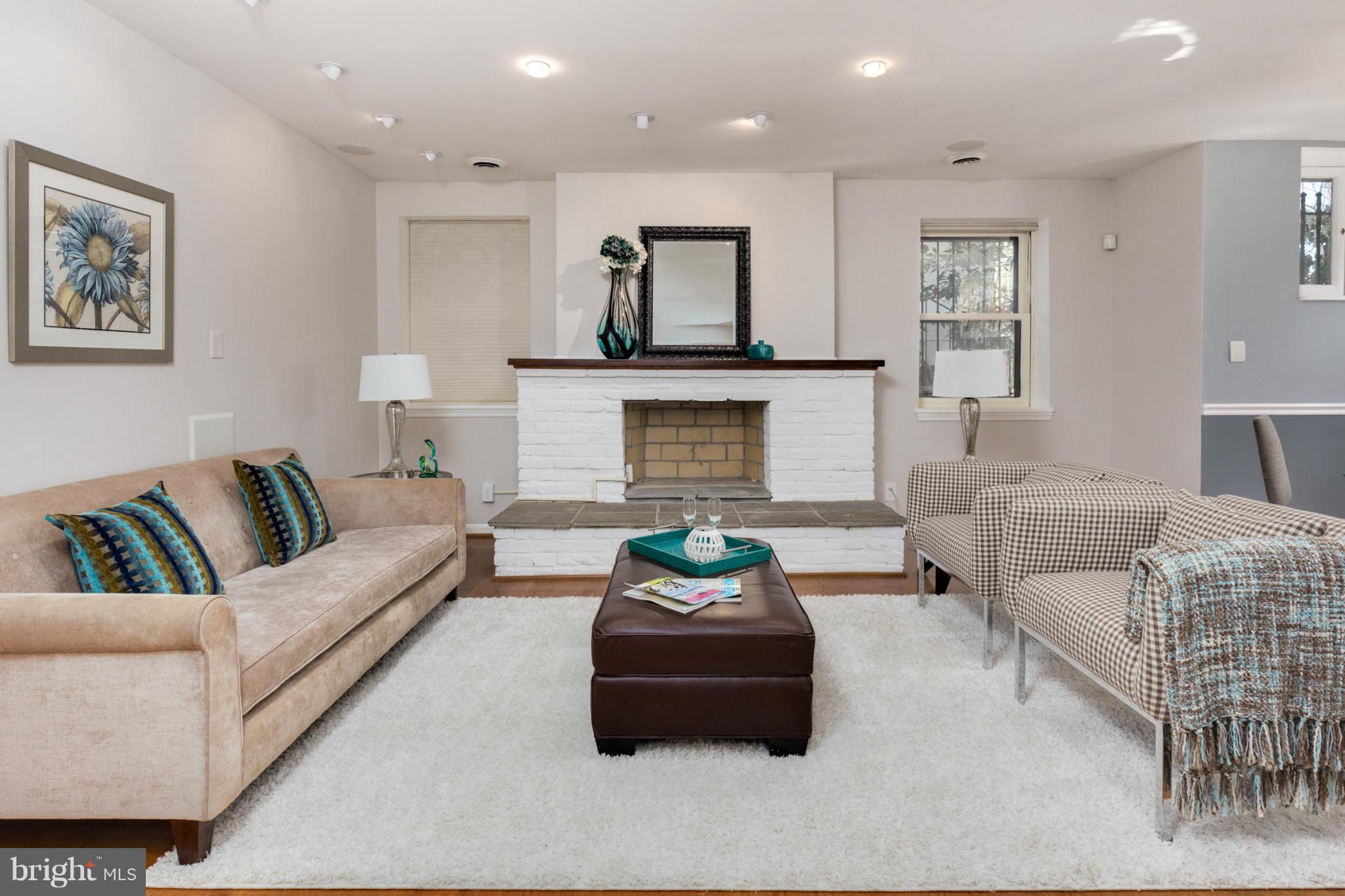 3035 Q Street Northwest, Unit 1 Washington, DC 20007 - Photo 3 of 19 a living room with furniture and a fireplace