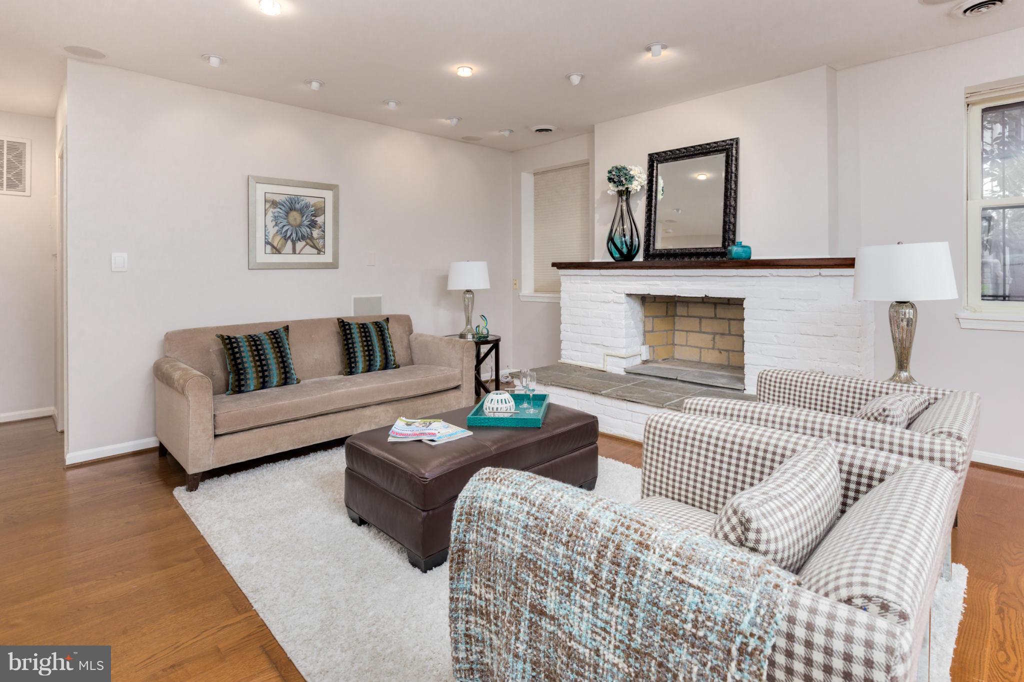 3035 Q Street Northwest, Unit 1 Washington, DC 20007 - Photo 4 of 19 a living room with furniture and a fireplace