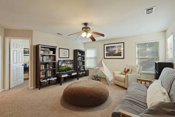 a bedroom with a bed dresser and a window