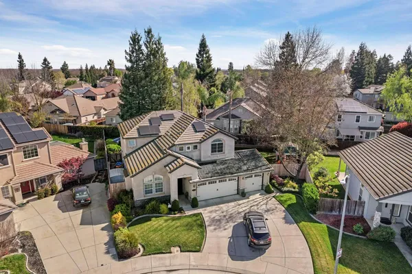 an aerial view of a house with garden space and street view