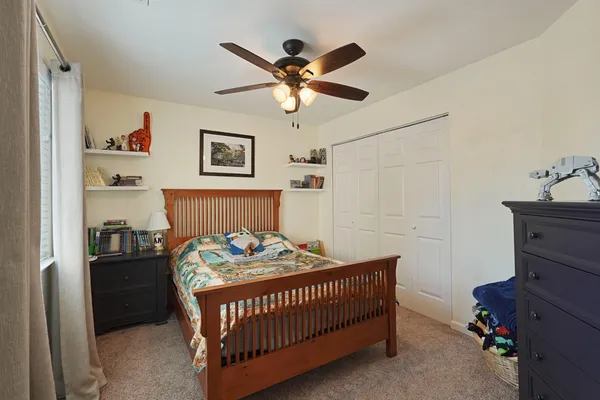a bedroom with a bed and a chandelier
