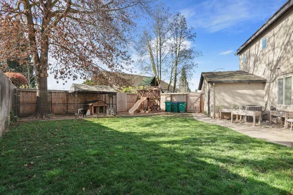 a front view of a house with garden and sitting area