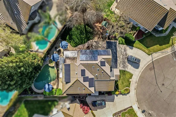 an aerial view of residential house with outdoor space and parking