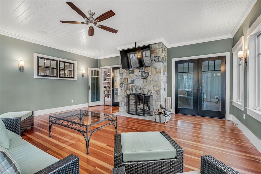 134 Pope Road Acton, MA 01720 - Photo 16 of 39 a living room with furniture a fireplace and a flat screen tv