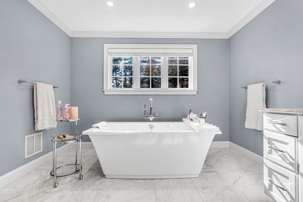 134 Pope Road Acton, MA 01720 - Photo 24 of 39 a white bath tub sitting in a bathroom