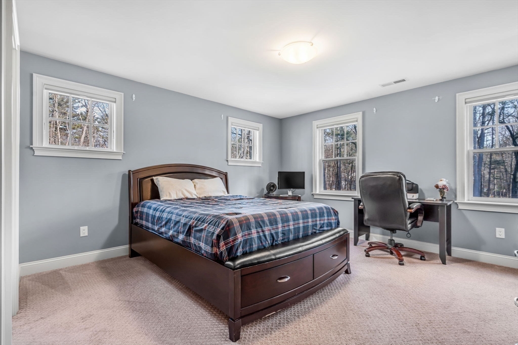 134 Pope Road Acton, MA 01720 - Photo 29 of 39 a spacious bedroom with a bed and window