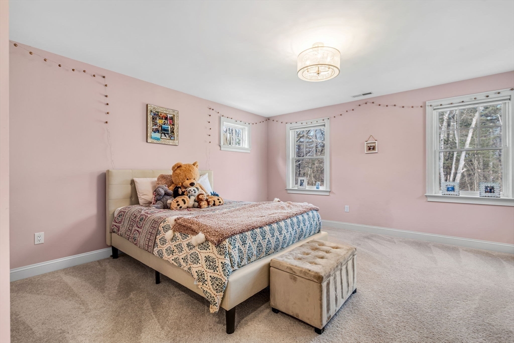 134 Pope Road Acton, MA 01720 - Photo 30 of 39 a bedroom with a bed and a window