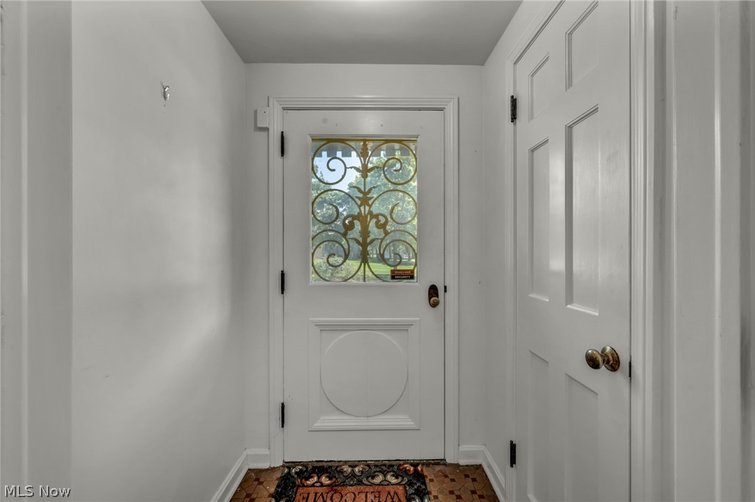 3543 Lytle Road Shaker Heights, OH 44122 - Photo 6 of 49 Entryway with a white door featuring decorative ironwork and a circular panel detail