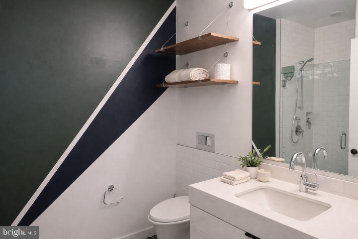 57 N Street Northwest, Unit 331 Washington, DC 20001 - Photo 9 of 18 a bathroom with a sink a toilet and shower