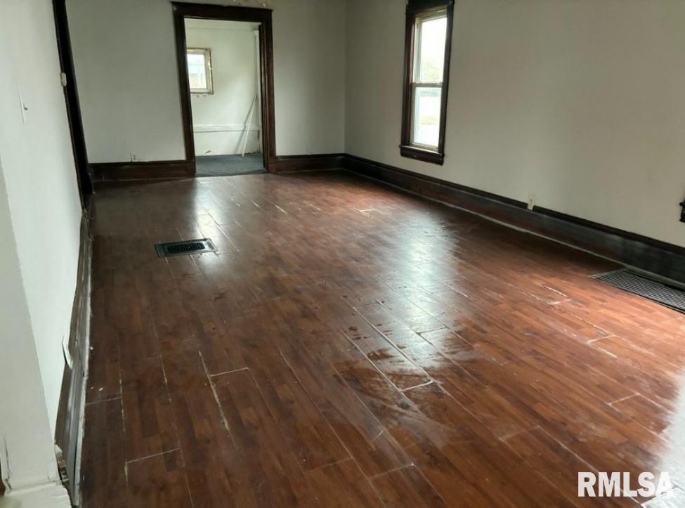 732 South Main Street Kewanee, IL 61443 - Photo 13 of 13 an empty room with wooden floor and windows