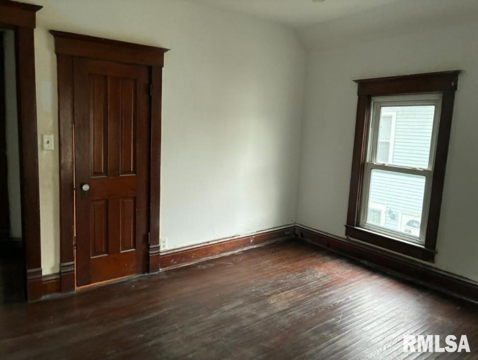 732 South Main Street Kewanee, IL 61443 - Photo 5 of 13 an empty room with wooden floor and windows