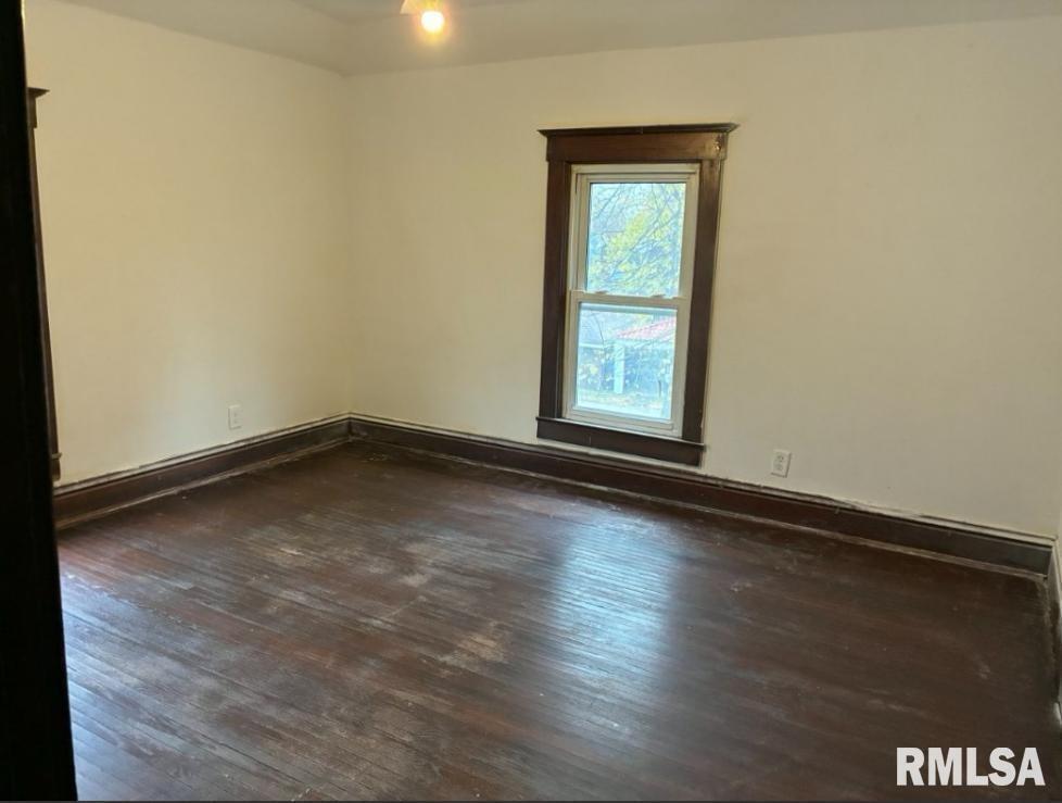 732 South Main Street Kewanee, IL 61443 - Photo 9 of 13 an empty room with wooden floor and windows