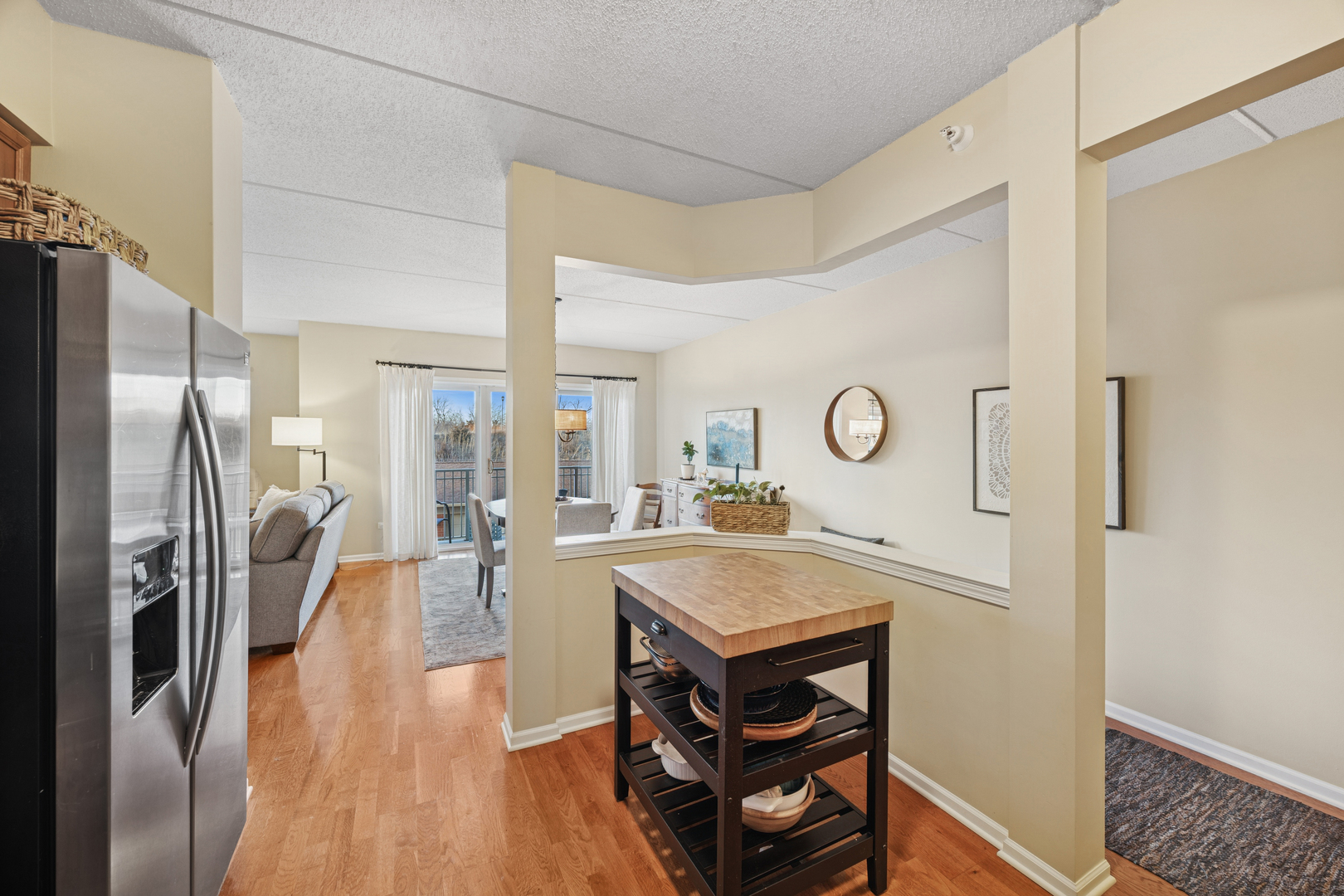 500 East St Charles Road, Unit 209 Lombard, IL 60148 - Photo 4 of 21 a view of a kitchen island with furniture and wooden floor