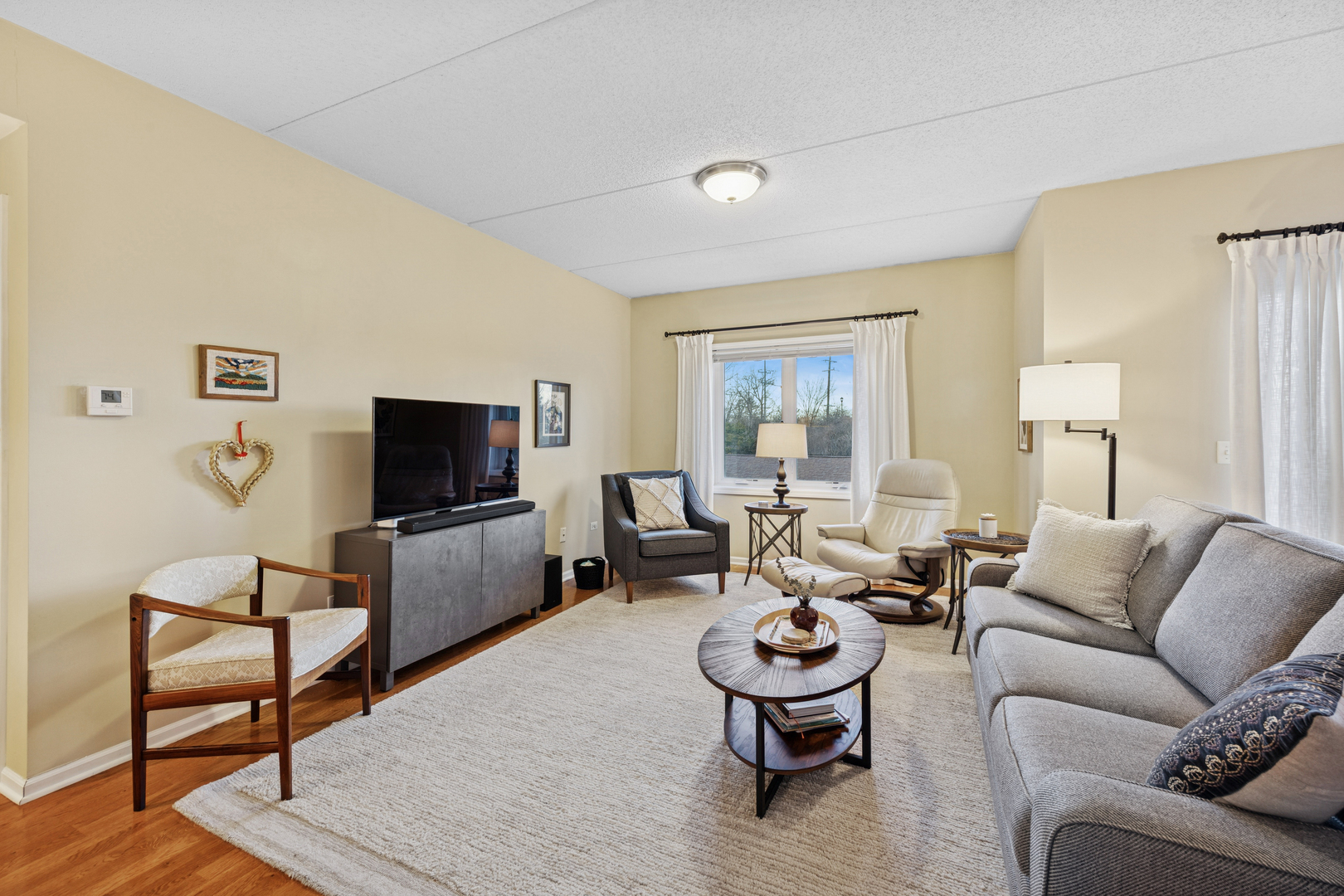 500 East St Charles Road, Unit 209 Lombard, IL 60148 - Photo 8 of 21 a living room with furniture and a flat screen tv