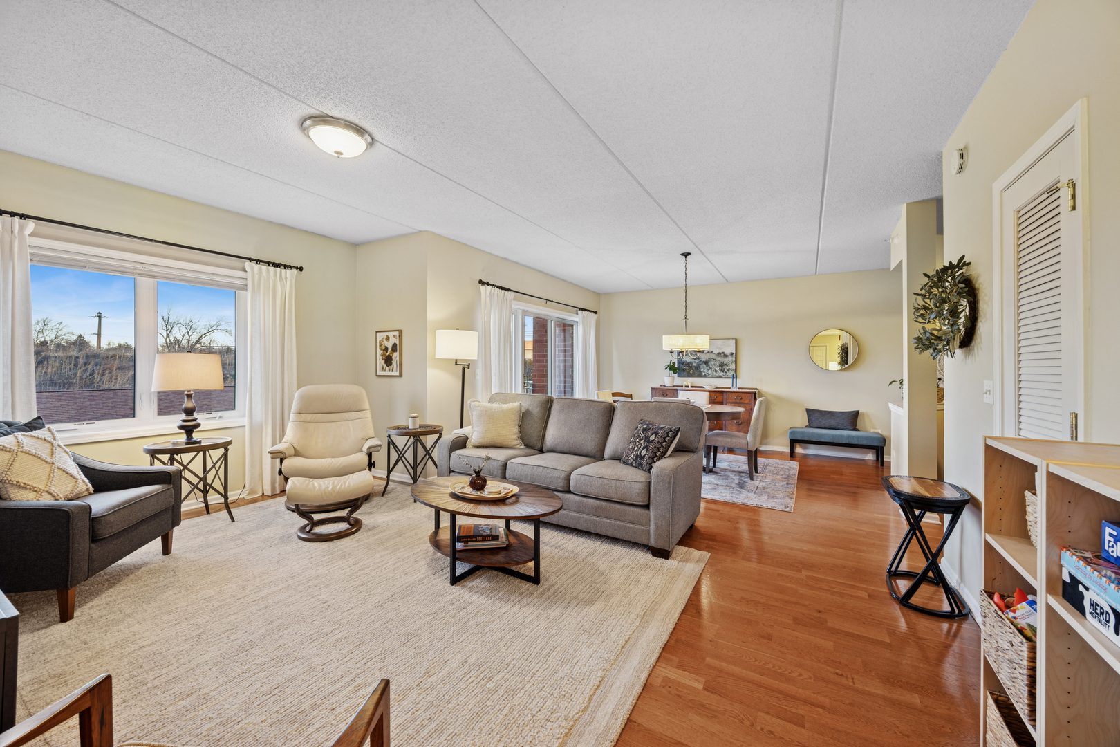 500 East St Charles Road, Unit 209 Lombard, IL 60148 - Photo 10 of 21 a living room with furniture and a wooden floor