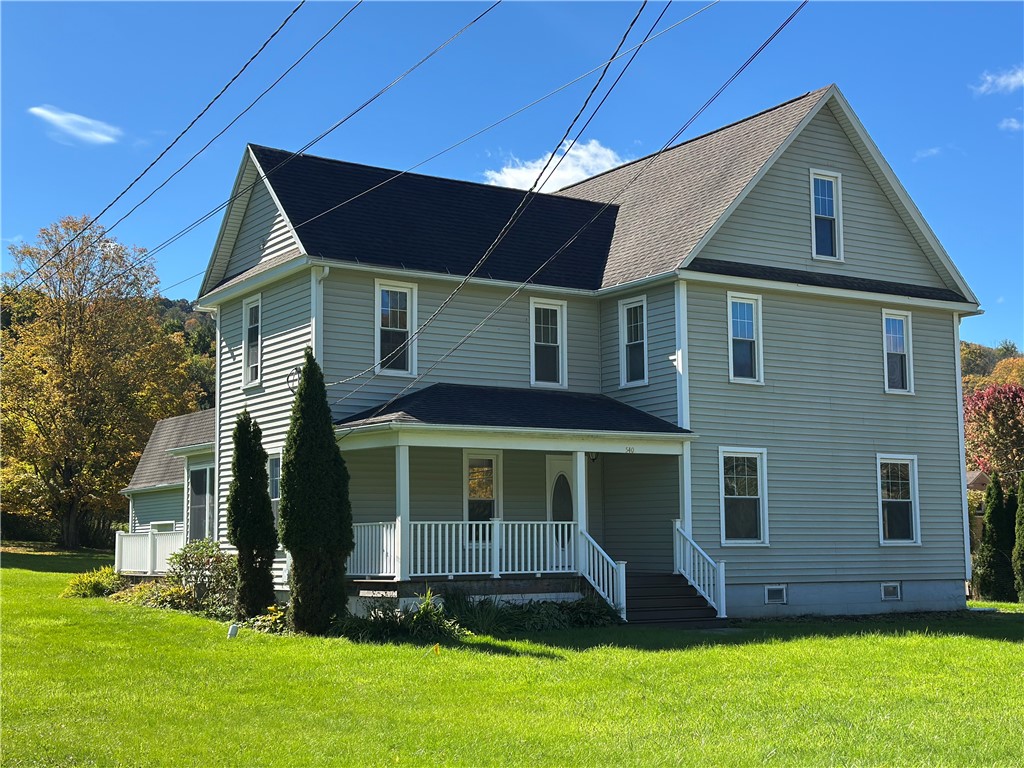 Classic siding and a welcoming front porch define