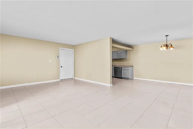 a view of an empty room with a kitchen
