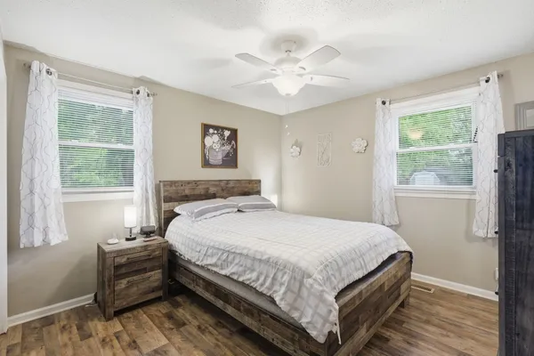 a bedroom with a bed and a window