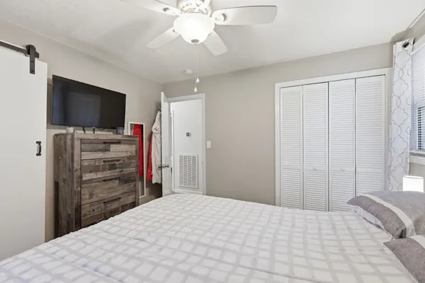 a bedroom with a bed and a flat screen tv