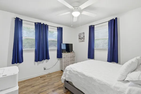 a bedroom with a large bed and a window