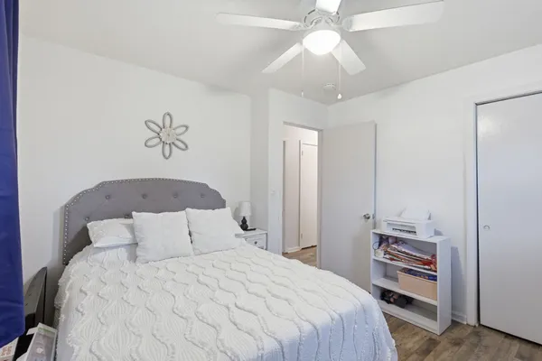 a bedroom with a bed and a chandelier