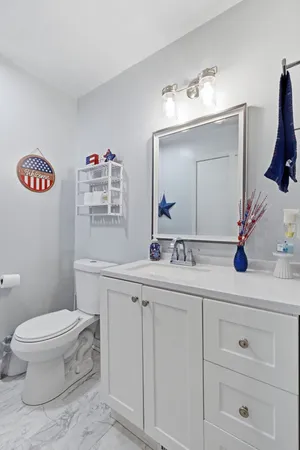 a bathroom with a sink a toilet and a mirror