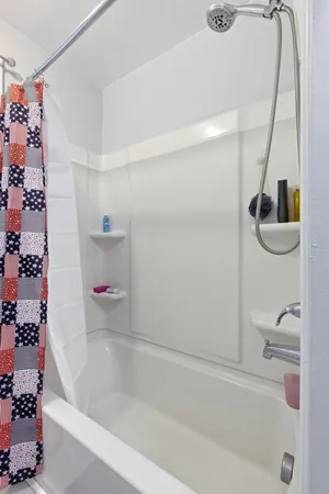 a bathroom with a bathtub and a shower