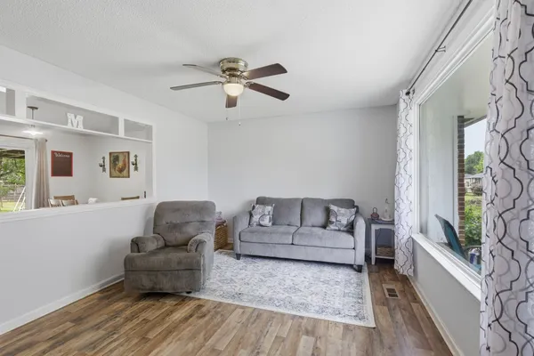a living room with furniture and a wooden floor