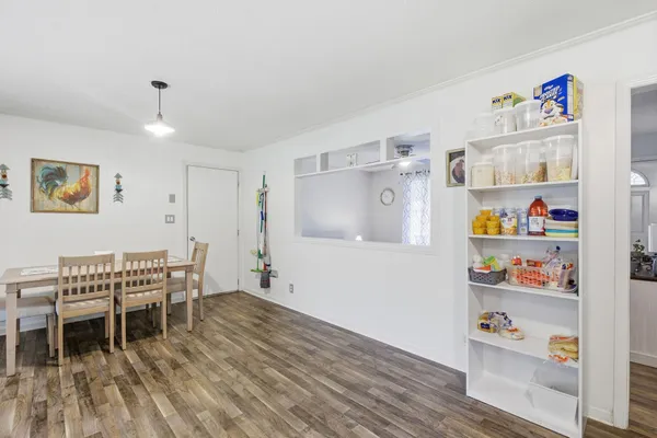 a dining room with furniture and wooden floor