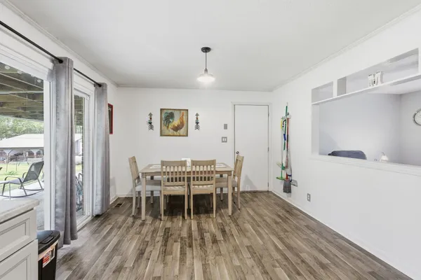 a dining room with furniture and wooden floor