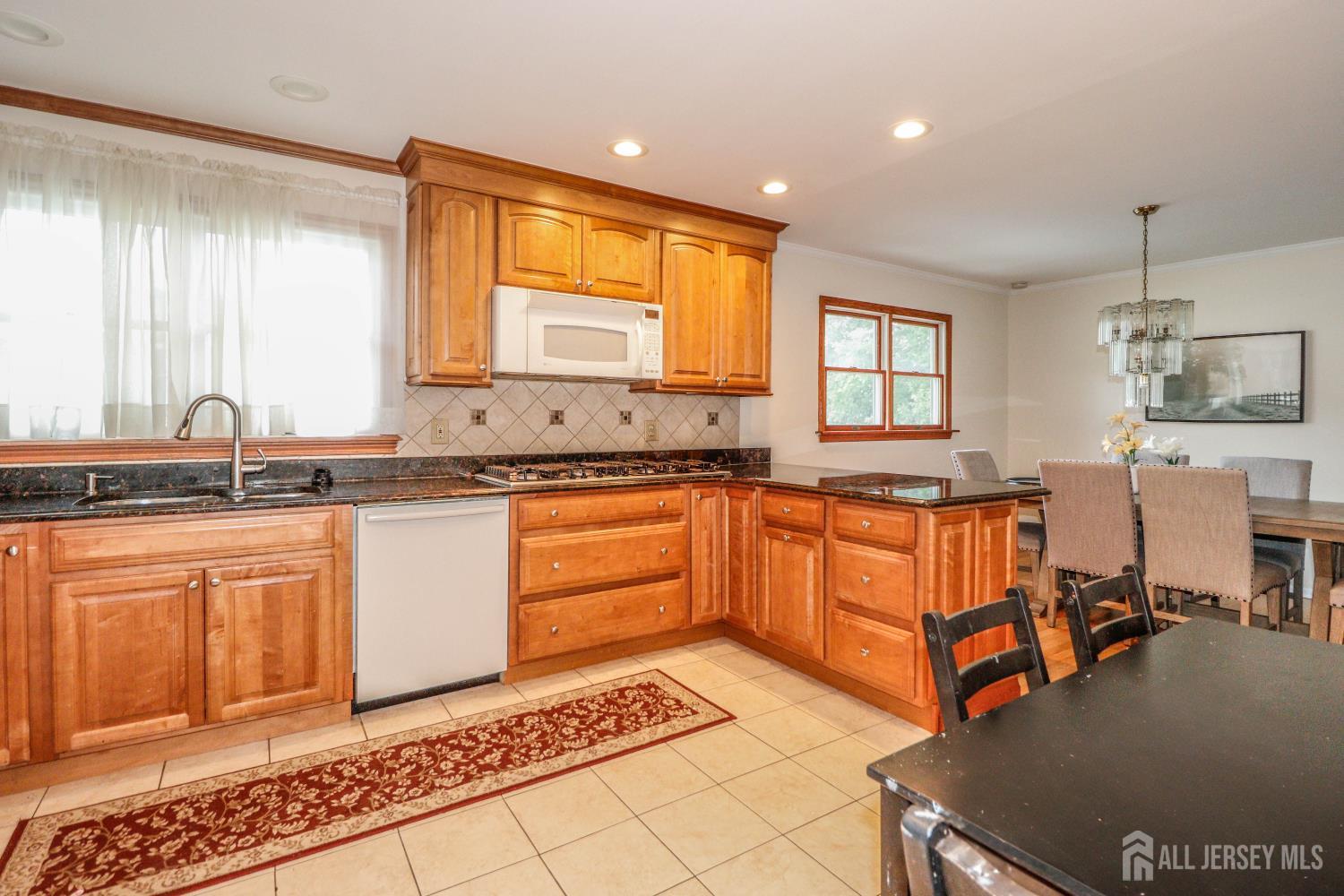 5 Timothy Court Edison, NJ 08837 - Photo 13 of 32 a kitchen with stainless steel appliances granite countertop a sink and cabinets
