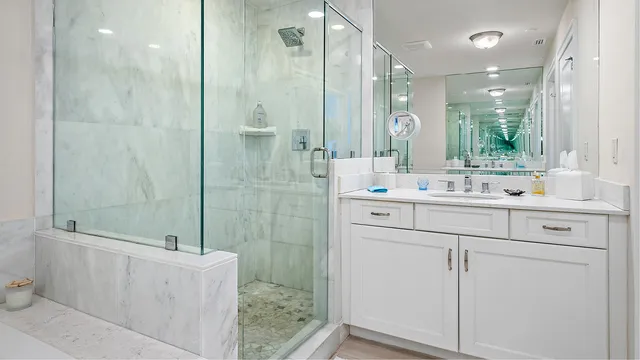 a bathroom with a bathtub shower sink vanity and toilet