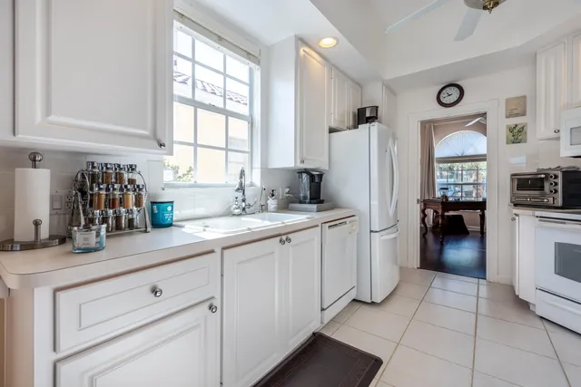 a kitchen with a refrigerator and a sink
