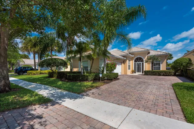 a view of a white house with a yard