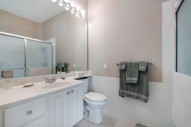 a bathroom with a sink toilet and mirror