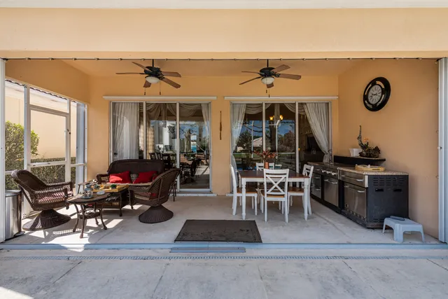 a view of a patio with table and chairs